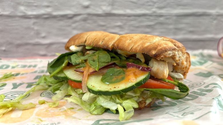 Side view of Subway Grilled Chicken & Avocado sandwich on wrapper