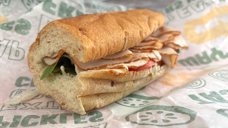 Side view of Subway Turkey & Ranch Delite sandwich on wrapper
