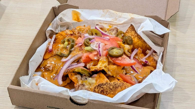 Chicken Doritos Hot Honey Nachos in a cardboard box lined with wax paper