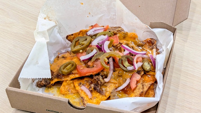 Steak Doritos Hot Honey Nachos in a cardboard box lined with wax paper