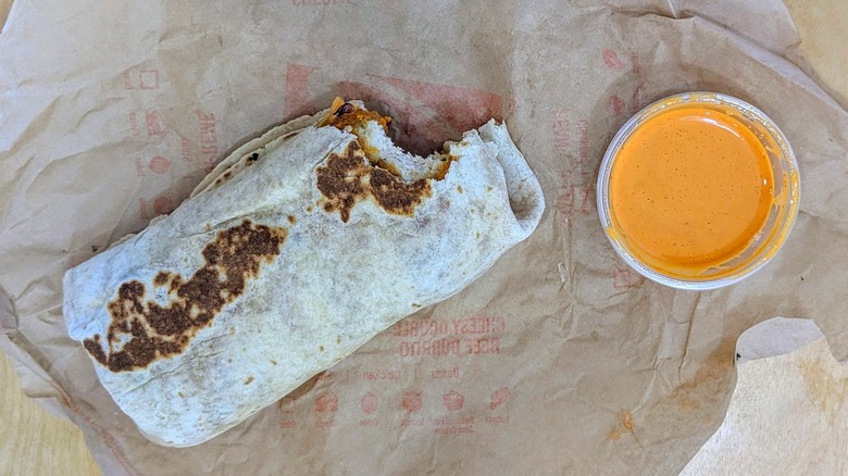 Taco Bell Frank's RedHot Diablo Crispy Chicken Burrito with cup of sauce