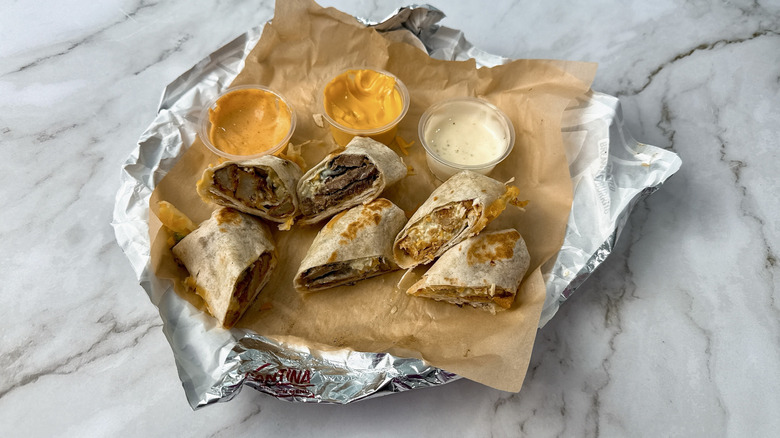 Taco Bell Cheesy Dipping Burritos with three sauces