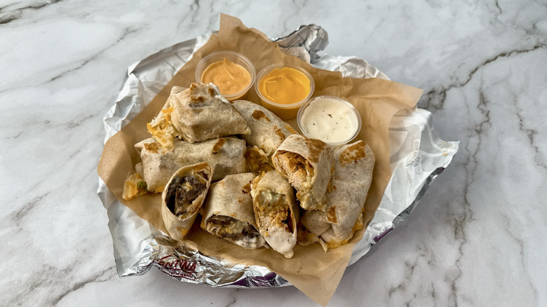 Taco Bell Cheesy Dipping Burritos with three sauces