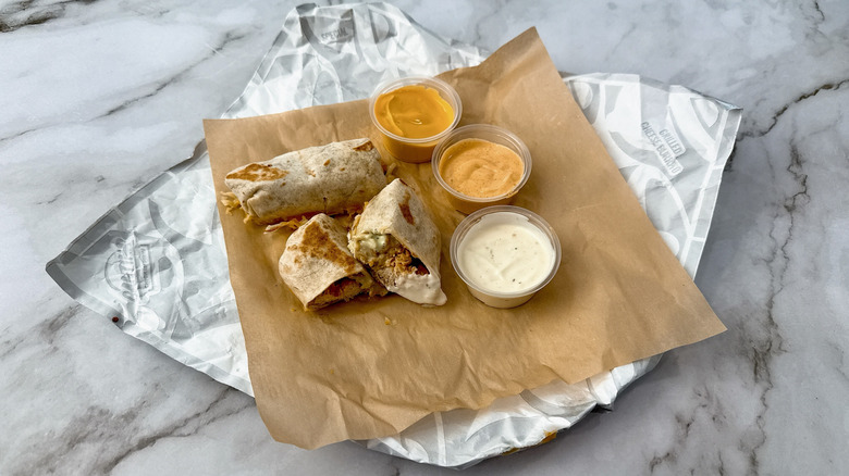 Taco Bell Slow Roasted Chicken Cheesy Dipping Burritos with three sauces