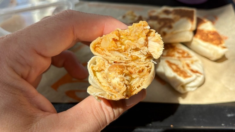 A burrito with chicken and cheese
