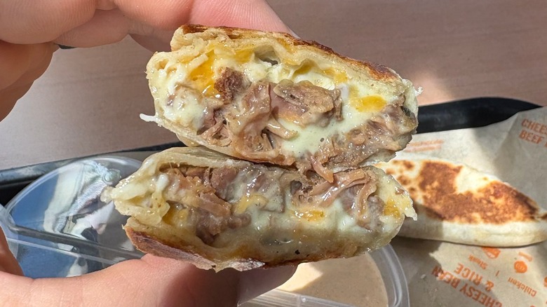 A steak burrito cut in half