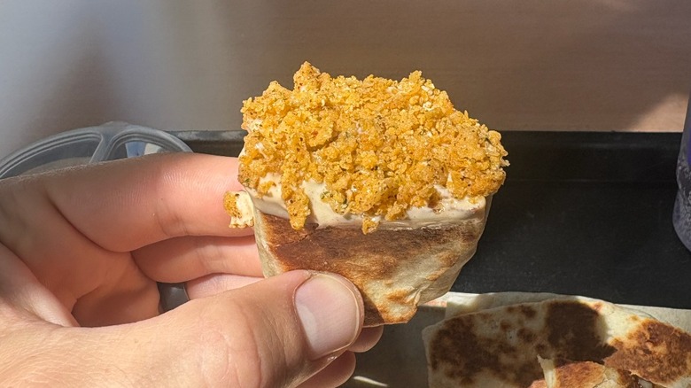 A burrito covered in crunchy bits