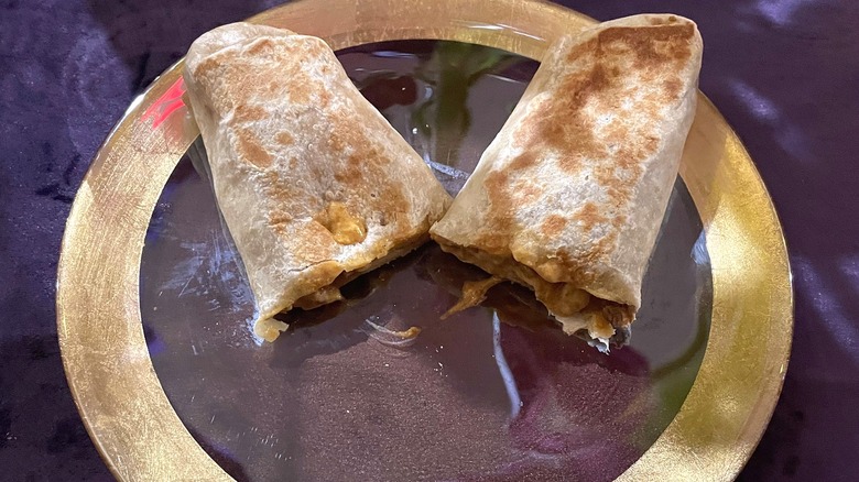 Taco Bell Luxe Value Menu Beefy Potato Loaded Griller split in two on plate