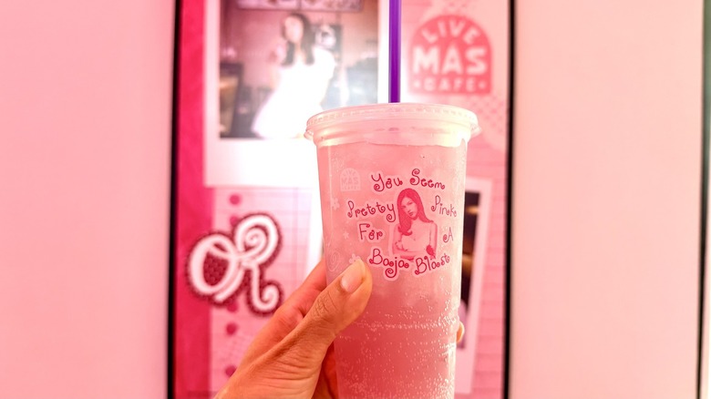 hand holding "You Seem Pretty Pink for a Baja Blast" in front of Olivia Rodrigo photo