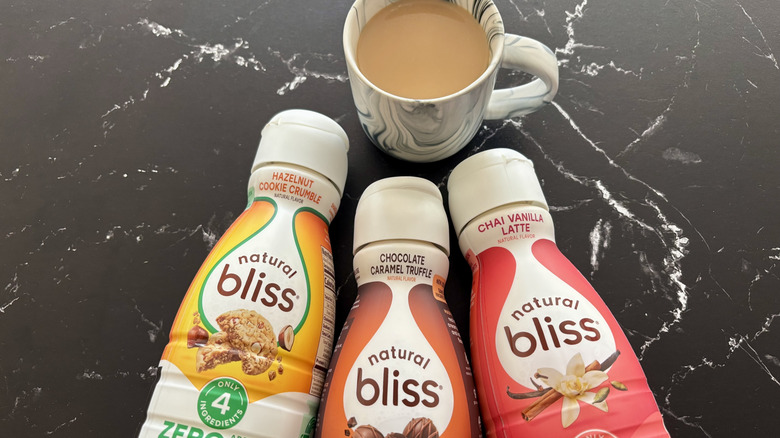 Natural Bliss coffee creamer bottles with cup of coffee
