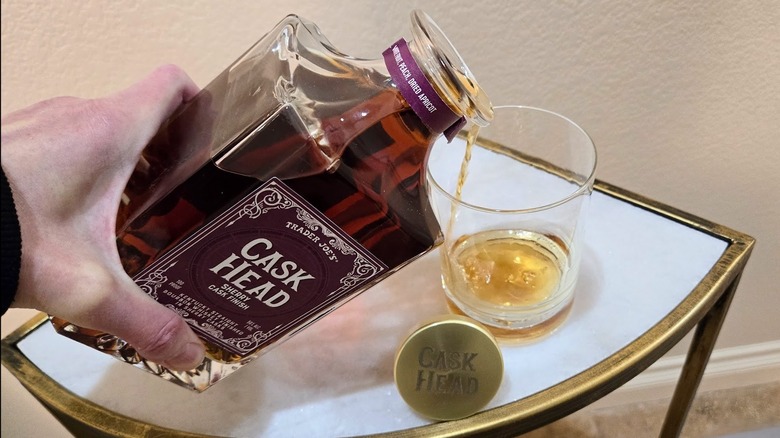 Pouring Cask Head bourbon into a glass