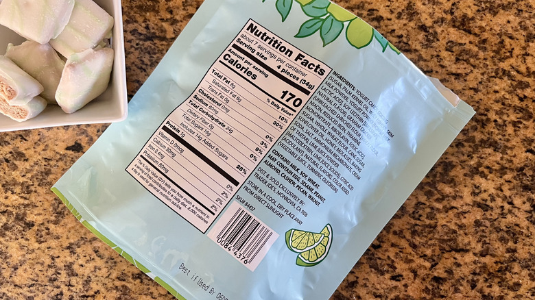 Trader Joe's Key Lime Inspired Grahams in a bowl next to rear of packaging, showing nutrition facts