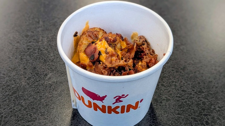 Dunkin' Chipotle Loaded Hash Browns on table in store