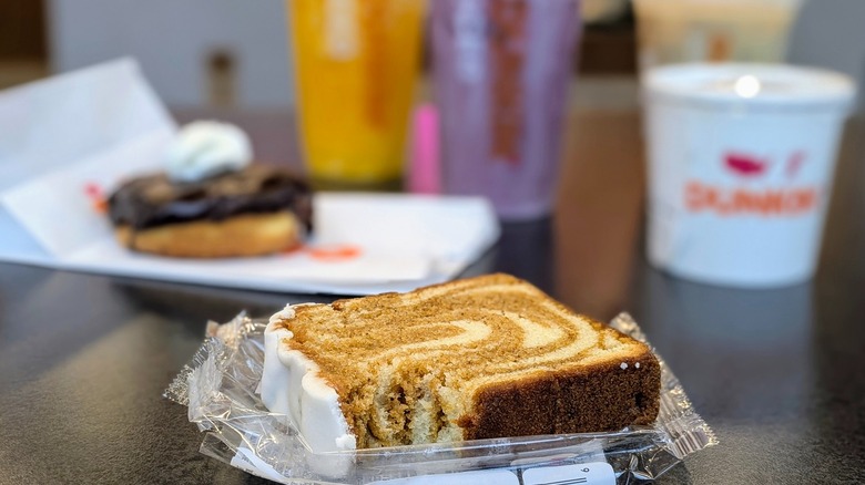 Dunkin' Iced Pumpkin Loaf with other new fall 2025 menu items in the background