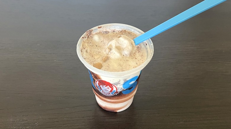 Wendy's new vanilla Cookie Dough Frosty Fusion with blue spoon.