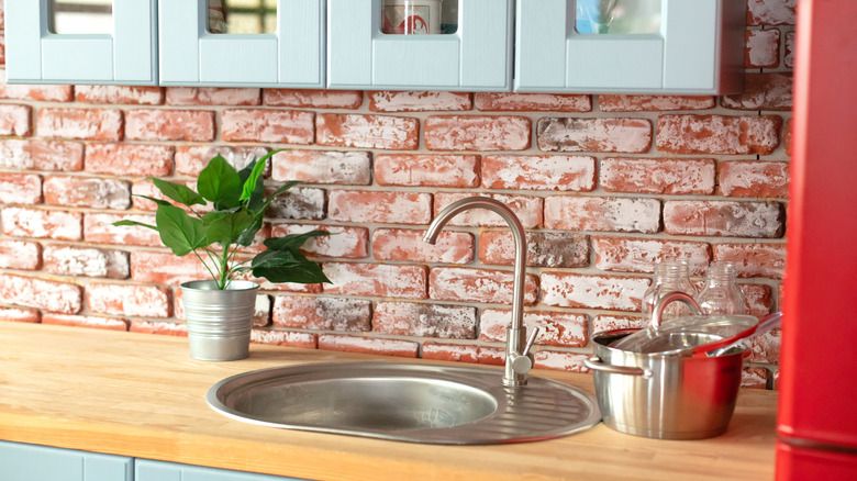Home kitchen with brick walls