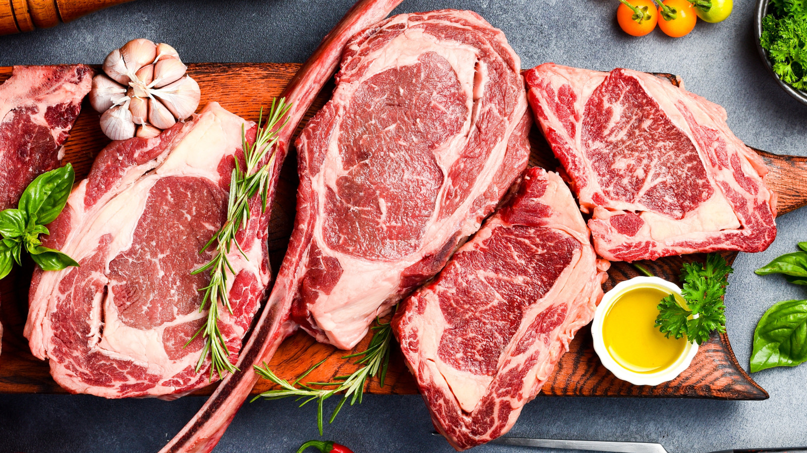 Ribeye And Tomahawk Steaks Come From The Same Cut — So What's The Difference?