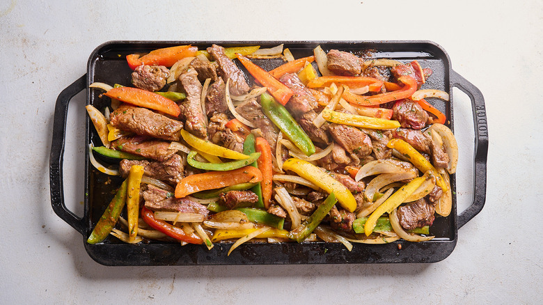 cooking fajitas on a cast iron