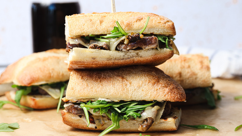 Two ribeye steak sandwiches stacked one on the other