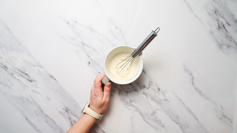 Holding small ramekin with aioli
