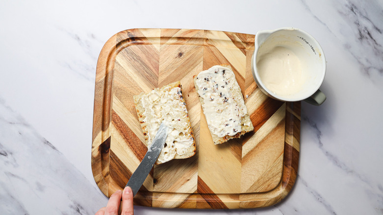Spreading aioli on bread