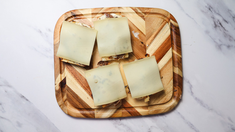 Sandwich halves topped with cheese