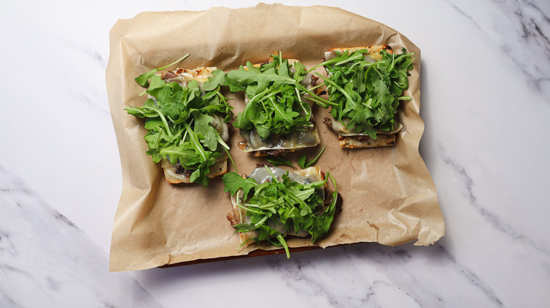 Steak sandwiches with broiled cheese and arugula