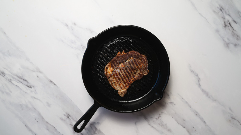 Cooked steak in a cast iron pan