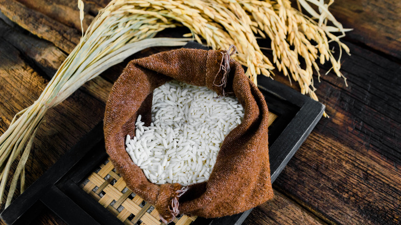 rice in burlap sack with wheat grains