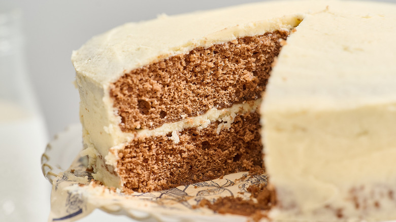 Mahogany cake with a slice removed on a cake stand