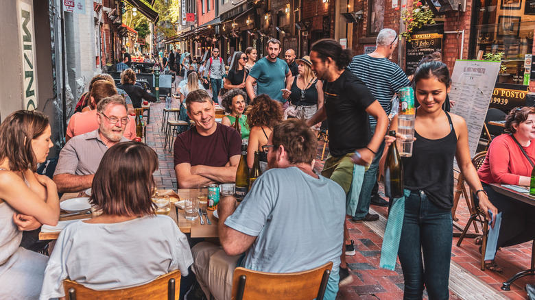 Busy restaurant outdoor space with people eating and drinking