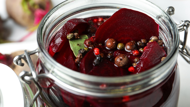 an opened jar of beets with chopped beets in liquid