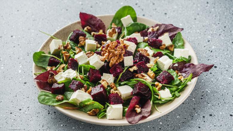 beet salad with lettuces, cheese, and walnuts