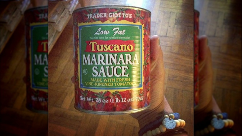 white bowl of marinara sauce on white background