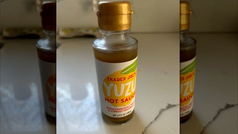 mirrored image of Trader Joe's Yuzu hot sauce on kitchen countertop