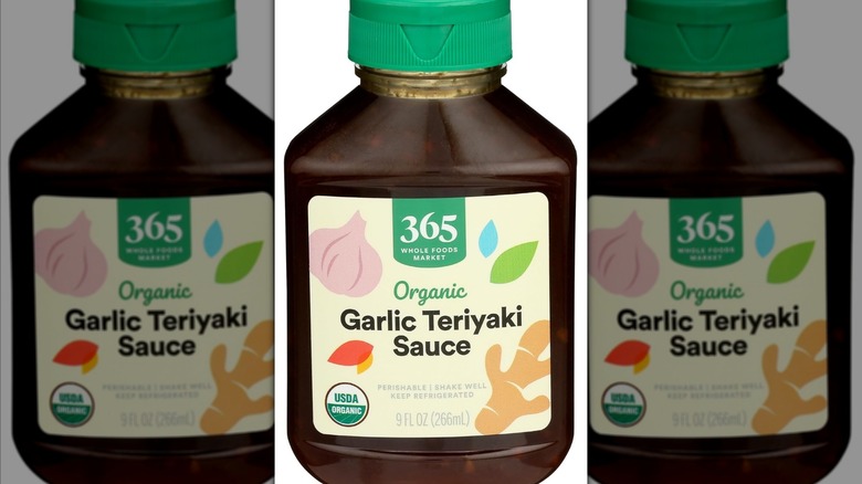 Mirrored image of Whole Foods Market 365 Organic Garlic Teriyaki Sauce bottle against white background