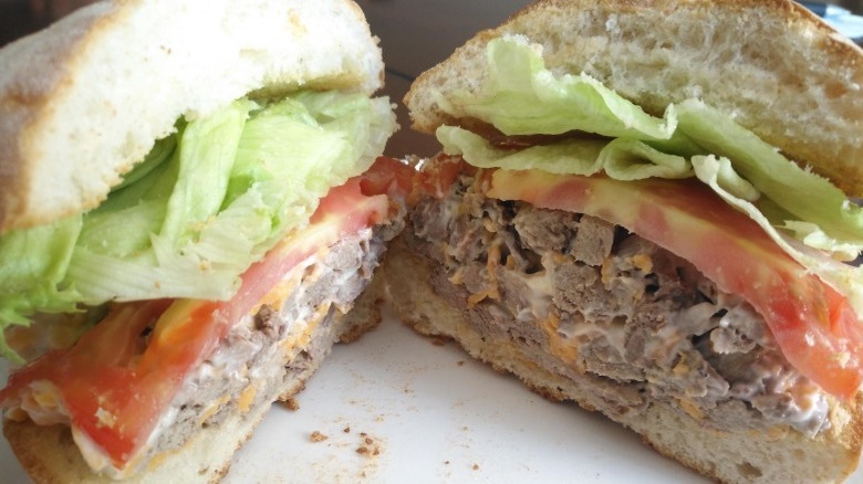 close up of roast beef salad sandwich sliced in half