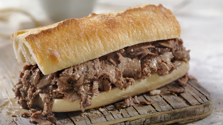 a French dip sandwich on wood board