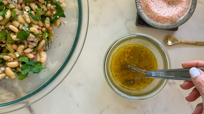 hand mixing dressing in bowl
