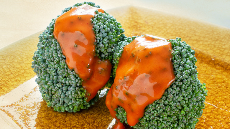 Two florets of broccoli with Catalina dressing