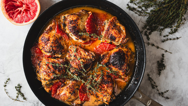 Chicken in pan with grapefruit and thyme