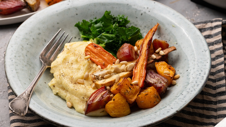 roasted root vegetable over polenta with pine nuts