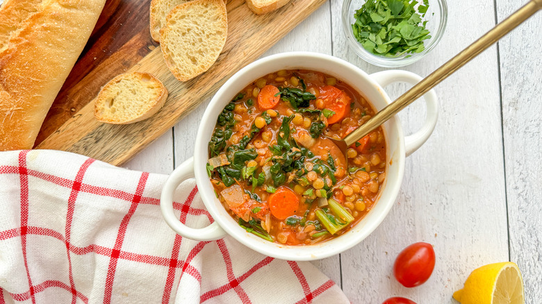 lentil vegetable soup in bowl with spoon