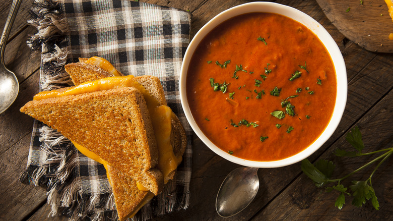grilled cheese sliced beside tomato soup