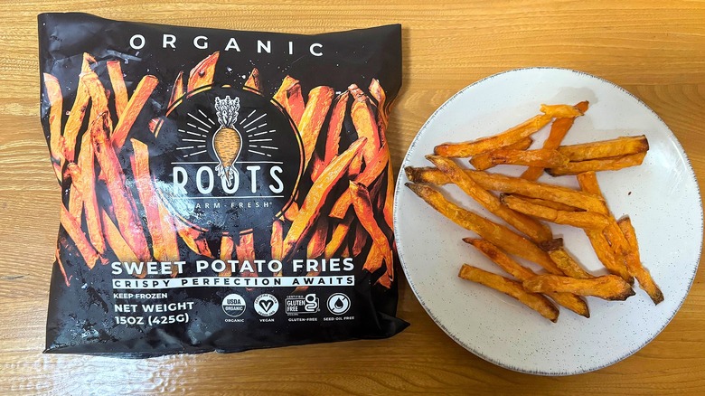 Roots Sweet Potato Fries bag next to fries on white plate