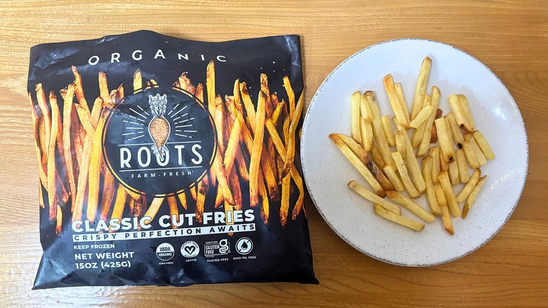 Roots Classic Cut Fries bag next to fries on white plate