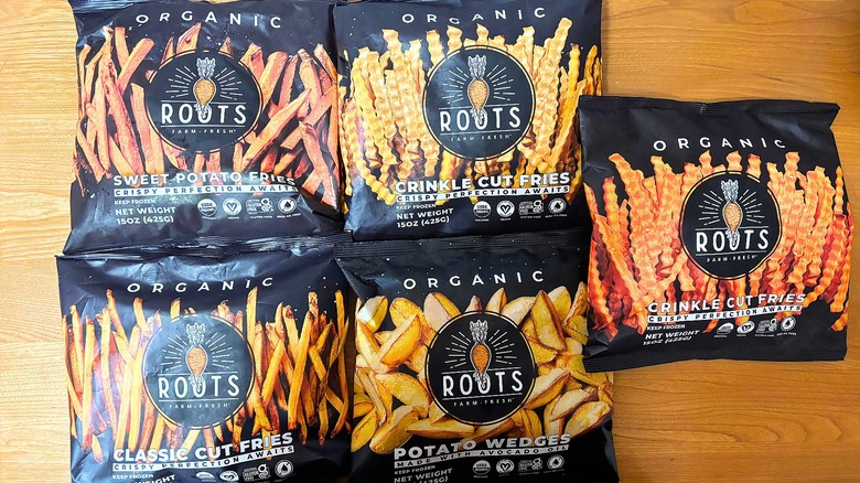 Five bags of Roots fries on wooden table