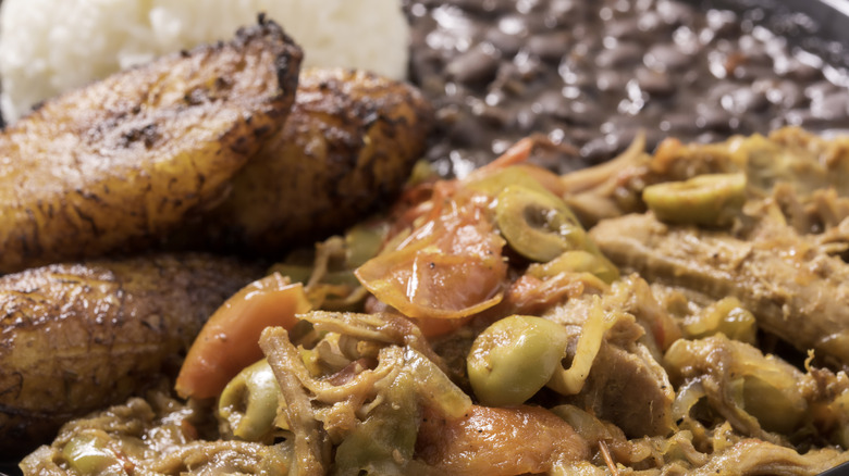 closeup of ropa vieja with black beans, rice, and plantains