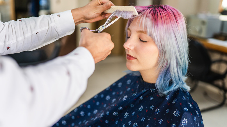 women with multi-colored hair gets haircut