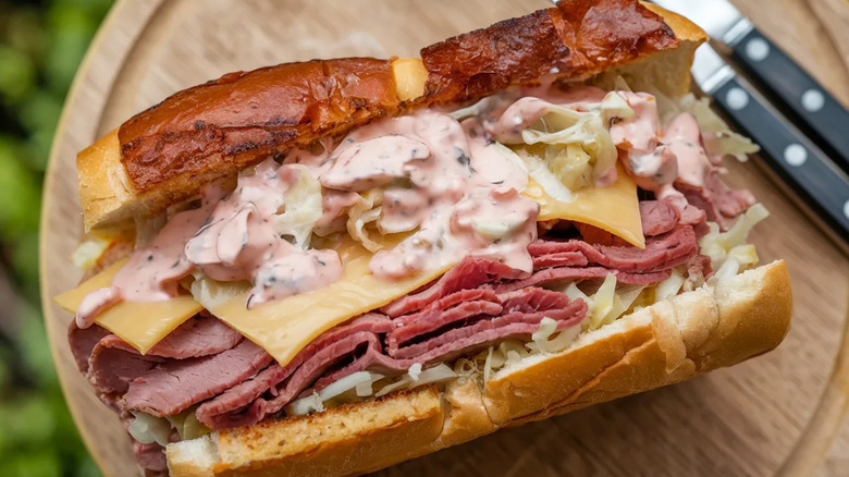 A Reuben sandwich with prominently oozing dressing